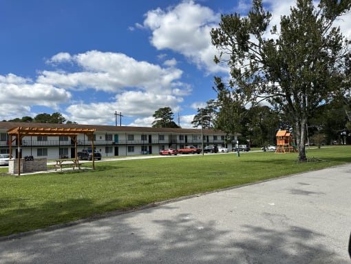 the building where the motel is located has a park in front of it