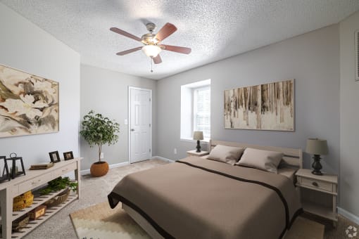 a bedroom with a large bed and a ceiling fan
