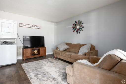 a living room with two couches and a television