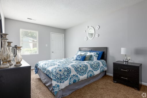 a bedroom with a bed and a dresser and a window