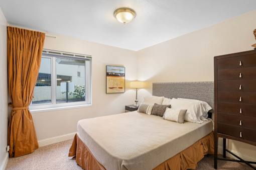 a bedroom with a large bed and a window