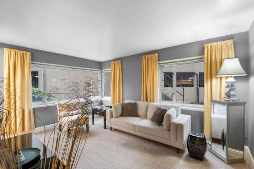 a living room with a couch and a dining room table