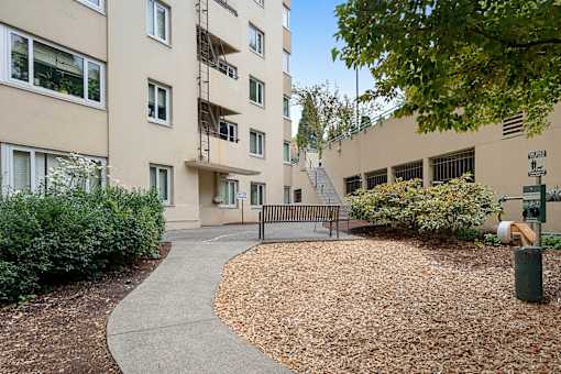 a park bench in front of an apartment building