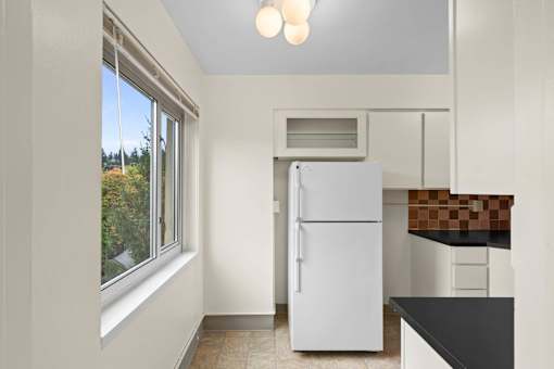 a kitchen with a refrigerator and a window