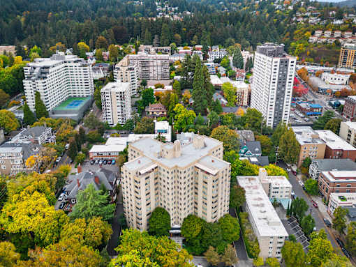 an aerial view of a city with buildings and trees