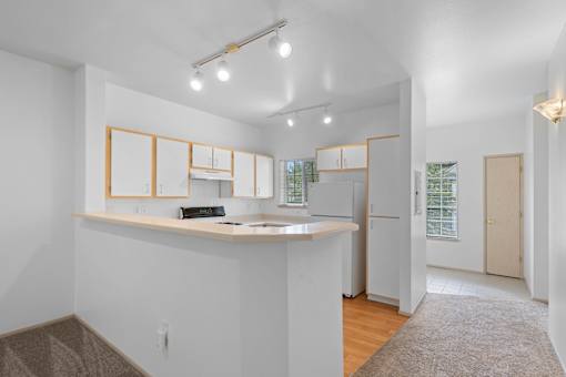 a kitchen with a counter top and a refrigerator at Oriel Apartments, Portland