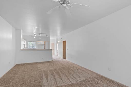 a living room with white walls and a ceiling fan at Oriel Apartments, Portland, Oregon