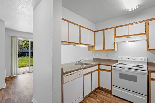 a kitchen with white appliances and wooden cabinets at Summer Creek Apartments, Tigard, OR, 97223