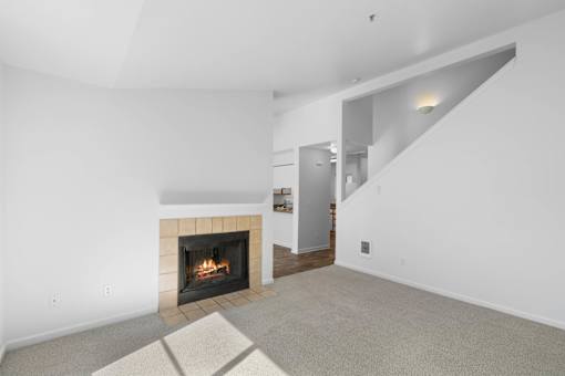 a living room with a fireplace and white walls at Summer Creek Apartments, Tigard, OR, 97223