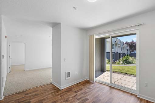 a living room with a sliding glass door to a patio at Summer Creek Apartments, Oregon, 97223