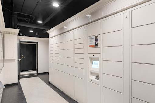 a storage room with white cabinets and a black ceiling