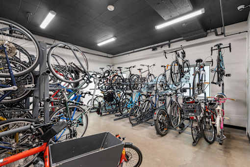 a bunch of bikes are hanging up in a bike shop