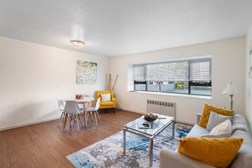 a living room with a couch and a table and a window