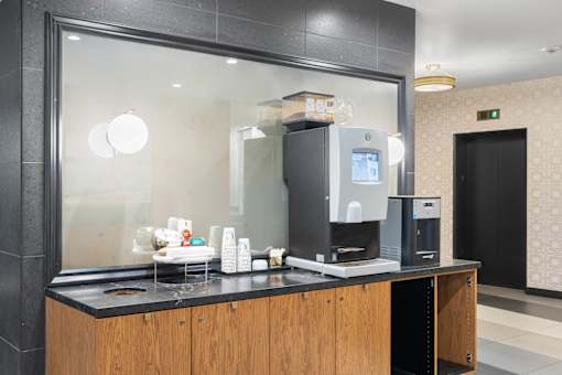 a coffee maker sitting on a counter in a hotel room