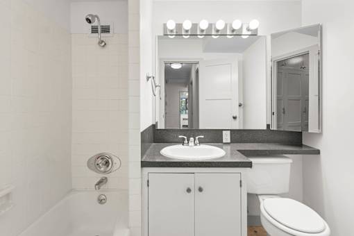 a white bathroom with a sink and a toilet