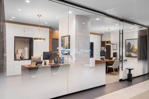 the kitchen and living room are separated by a glass wall
