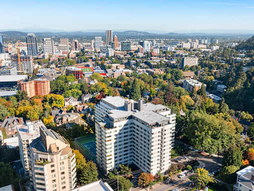 an aerial view of a city with tall buildings and trees