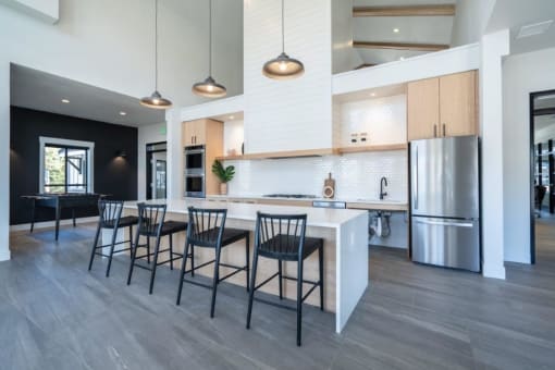 a kitchen with a large island and chairs at Sonder Fields in Happy Valley, OR