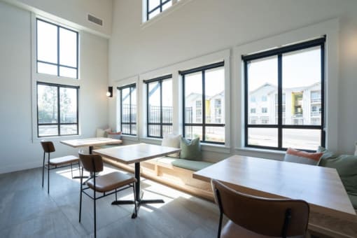 a tasting room with tables and chairs and large windows at Sonder Fields in Happy Valley, OR