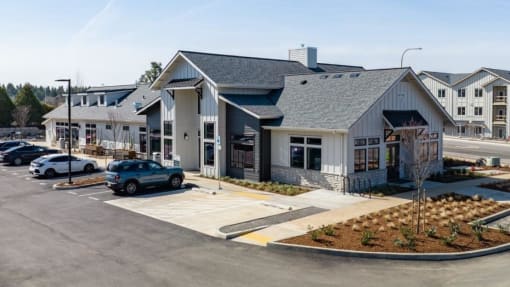 a building with a parking lot and cars in front of it at Sonder Fields in Happy Valley, OR