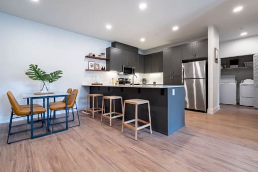 a kitchen and dining room with a table and chairs at Sonder Fields in Happy Valley, OR