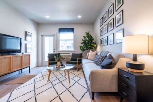a living room with a couch and a tv at Sonder Fields in Happy Valley, OR