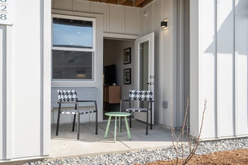 a patio with two chairs and a green stool at Sonder Fields in Happy Valley, OR