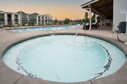 a large resort style swimming pool with a building in the background at Sonder Fields in Happy Valley, OR