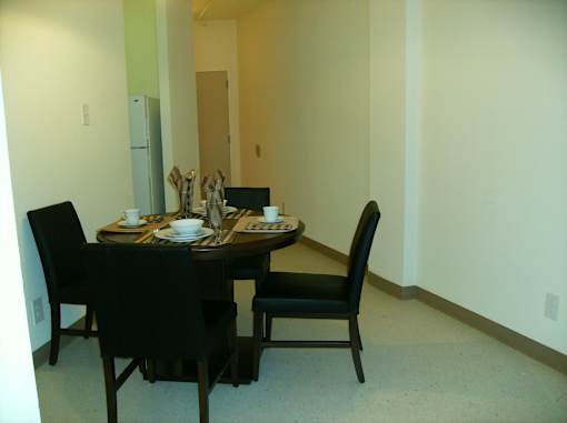 A dining table with four chairs around it.