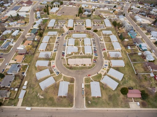 an aerial view of a circle shaped parking lot in a suburban neighbourhood