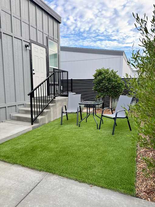 A small patio with a table and chairs.