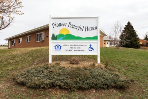 a sign sits in front of a house