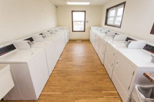 a washer and dryer room filled with white washing machines