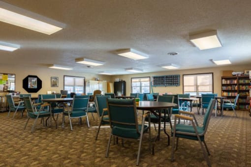 a dining room with chairs and tables in a library