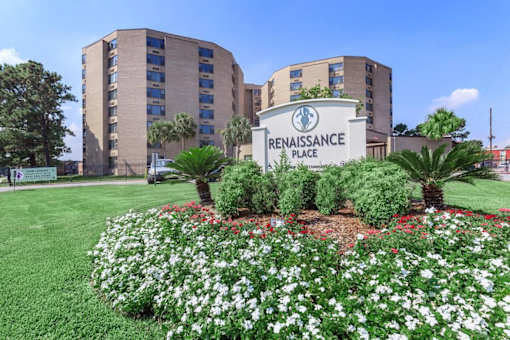 A sign that says Renaissance Place in front of a building.