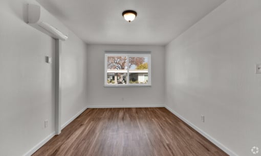 the living room of an empty house with a window