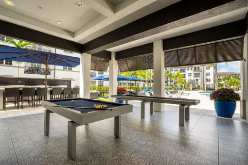a pool table in the lobby of a building with pool tables