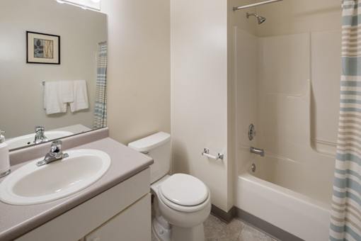A bathroom with a toilet, sink, and bathtub.