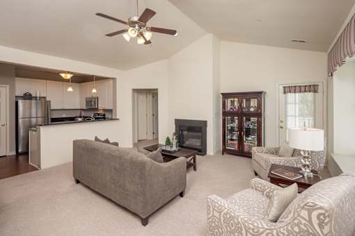 A living room with a grey couch and a television.
