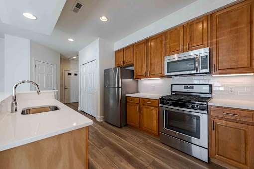 A kitchen with wooden cabinets and stainless steel appliances.