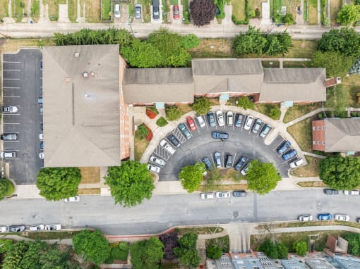 an aerial view of a neighborhood with cars parked in a parking lot
