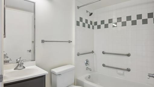 A white bathroom with a sink, toilet, and bathtub.