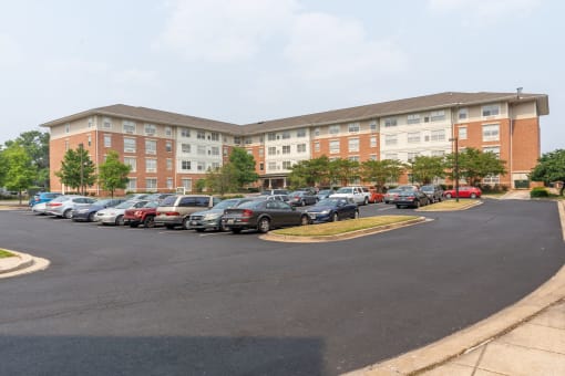 a large brick building with a parking lot in front of it