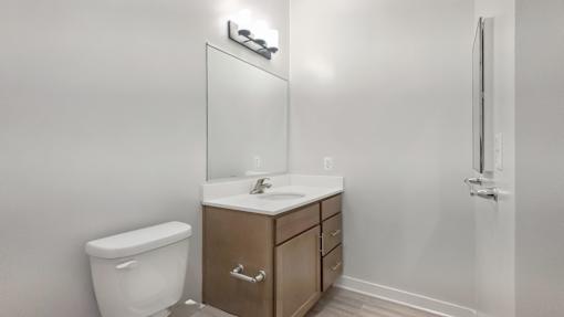 A white toilet sits next to a sink in a small bathroom.