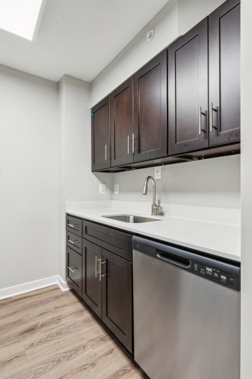 Modern, energy-efficient stainless steel appliances and sleek dark-tone cabinetry at Park Montgomery apartments located along the Purple Line in Silver Spring, MD.