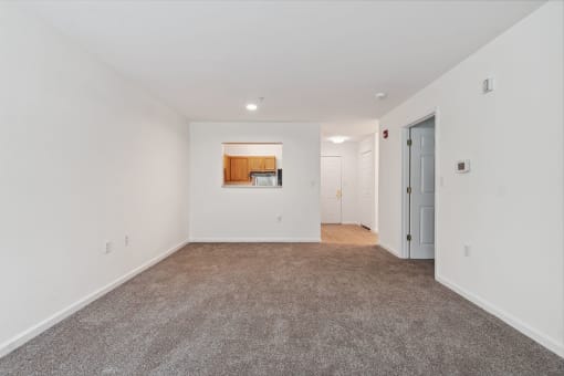 a bedroom with white walls and carpet