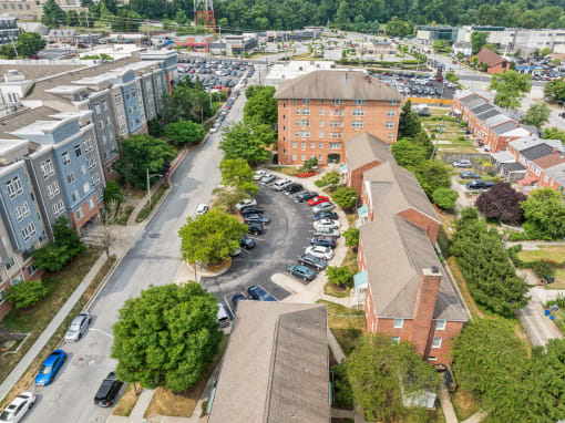 an aerial view of a city with buildings and parking lot