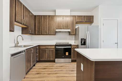 A kitchen with wooden cabinets and a white countertop.
