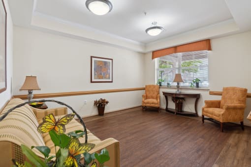 a living room filled with furniture and a large window