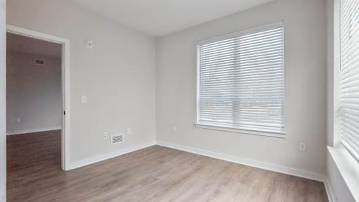 A room with a window and a door.